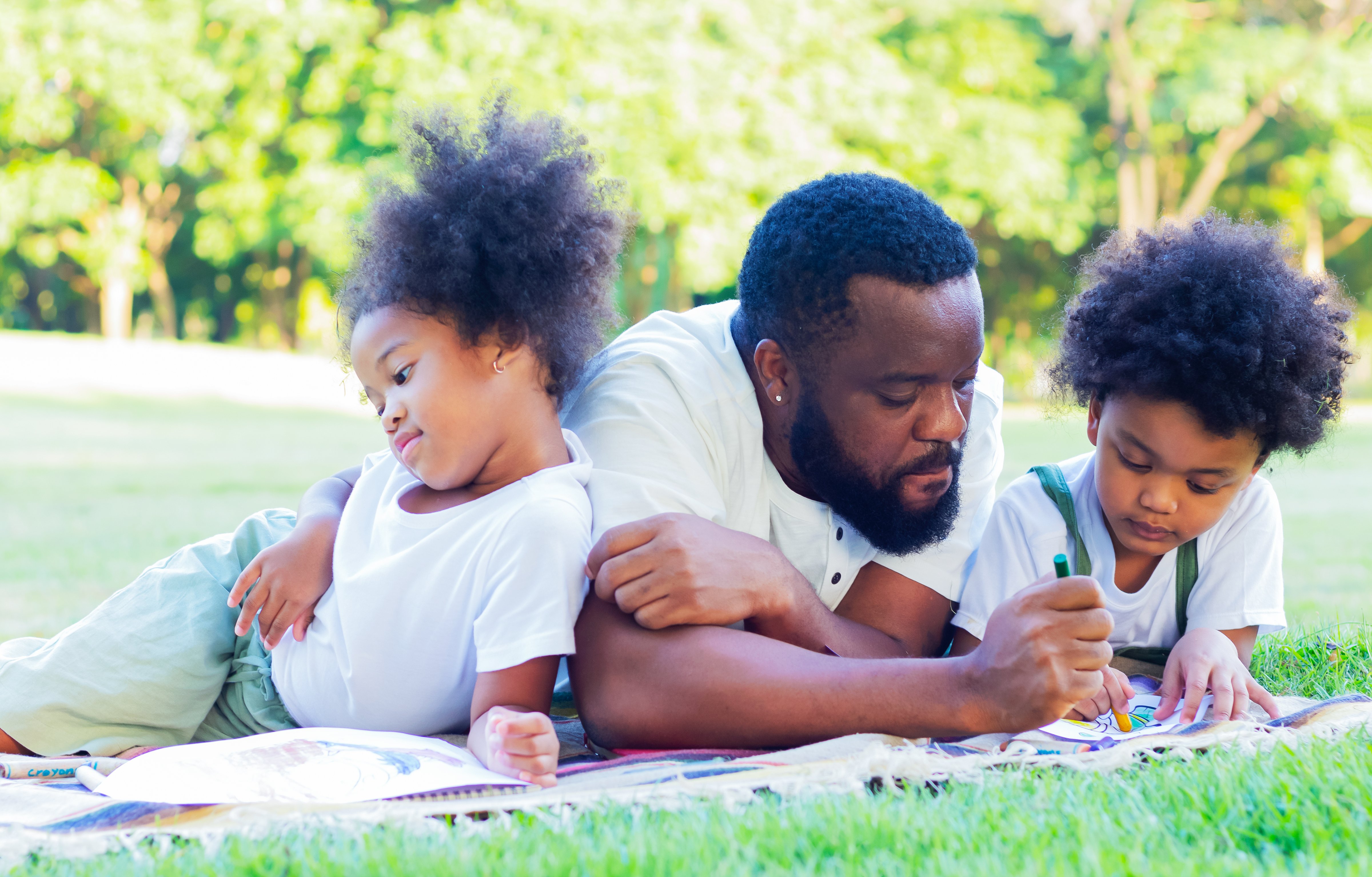 vecteezy_family-happy-to-lie-down-on-the-lawn-in-the-park-on_1898845