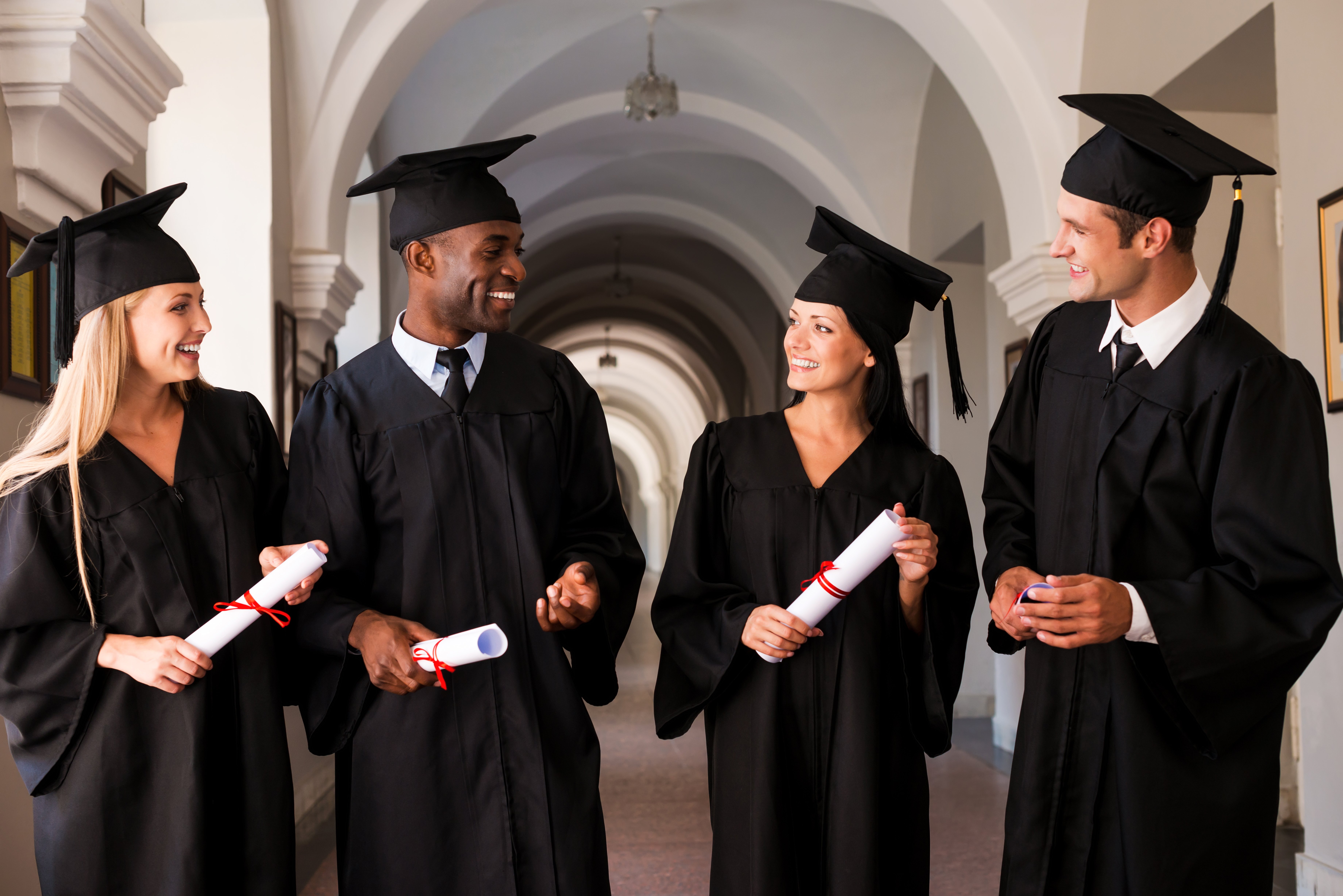 vecteezy_talking-about-bright-future-four-college-graduates-in_13540746